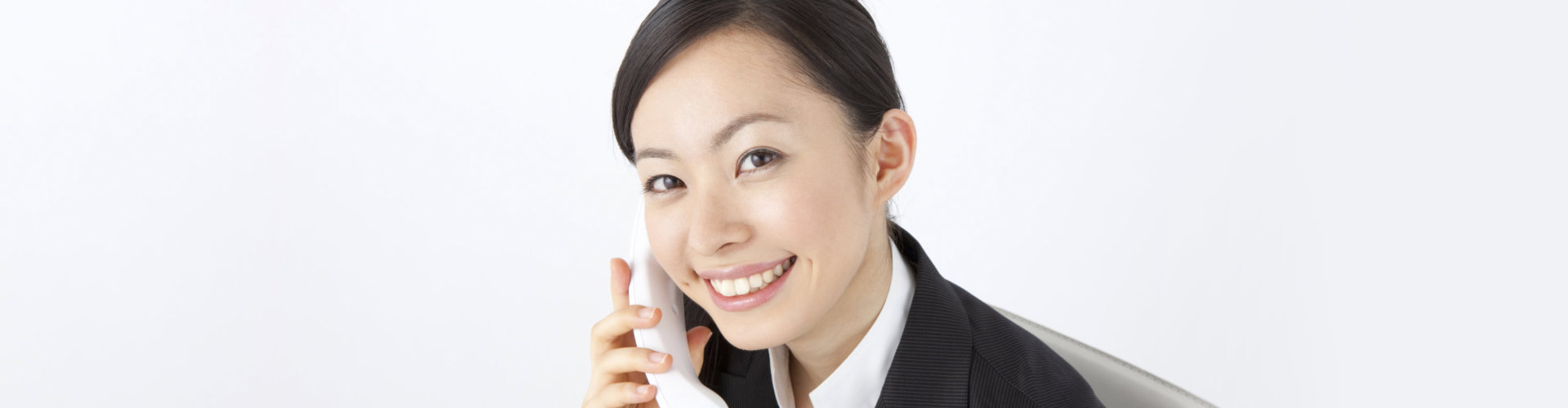woman smiling while on the phone